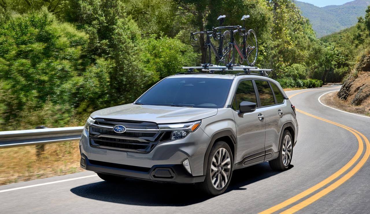 Front 3/4 view of the 2025 Subaru Forester driving on the road.